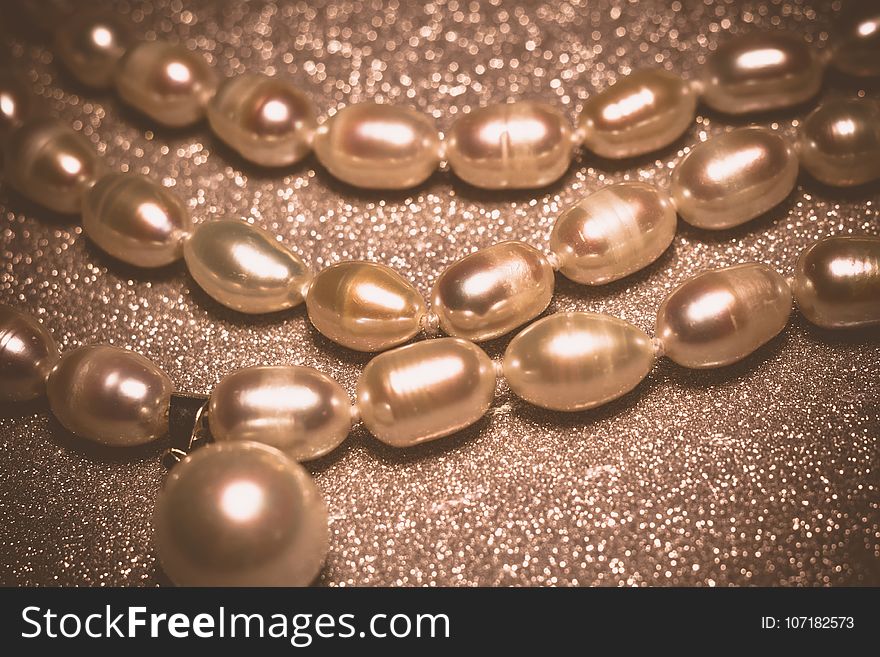 Natural white freshwater pearl necklace close up filtered background. Natural white freshwater pearl necklace close up filtered background.