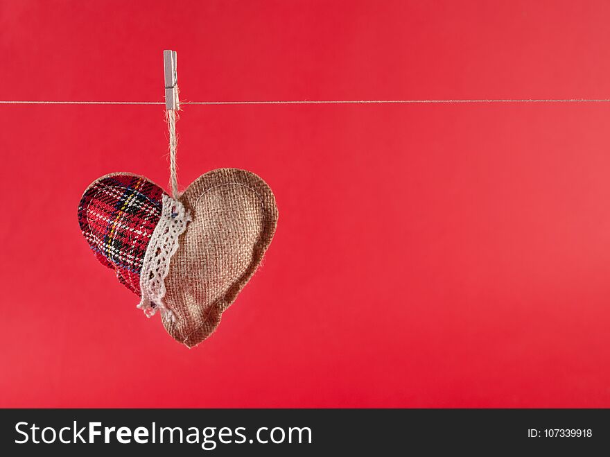 This captivating image features a heart symbol hanging on a rope with a clothes peg, set against a striking red background. The concept beautifully portrays the idea of love on display, as the heart symbol becomes a focal point. The red background intensifies the passionate and romantic atmosphere, perfectly complementing the Valentine's Day concept. With its simple yet powerful composition, the image invites viewers to celebrate love and express affection. The space for text allows for customization, making it ideal for Valentine's Day greetings or messages of love. This image captures the essence of heartfelt sentiment and adds a touch of warmth and charm to any Valentine's Day-themed project. This captivating image features a heart symbol hanging on a rope with a clothes peg, set against a striking red background. The concept beautifully portrays the idea of love on display, as the heart symbol becomes a focal point. The red background intensifies the passionate and romantic atmosphere, perfectly complementing the Valentine's Day concept. With its simple yet powerful composition, the image invites viewers to celebrate love and express affection. The space for text allows for customization, making it ideal for Valentine's Day greetings or messages of love. This image captures the essence of heartfelt sentiment and adds a touch of warmth and charm to any Valentine's Day-themed project.