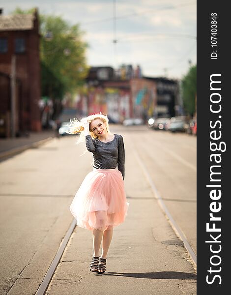 Portrait in full growth, young beautiful woman walking on the street, summer outdoors