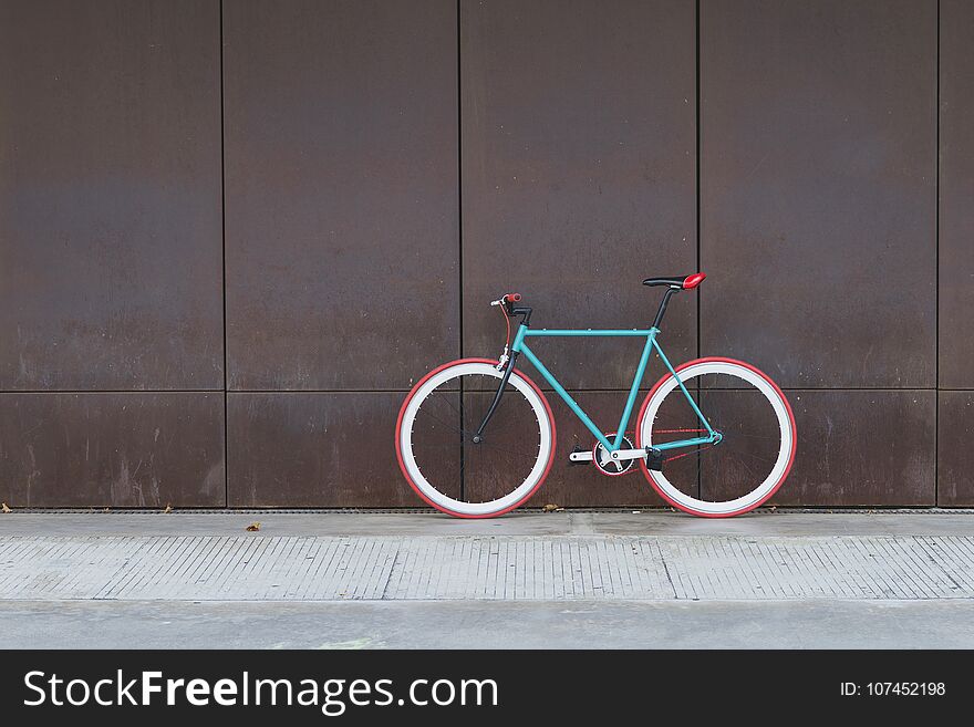 A City Bicycle Fixed Gear On A Brown Wall