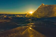 Pure Transparent Ice Of Lake Baikal Through The Sun Is Shining In The Sunset Royalty Free Stock Photography
