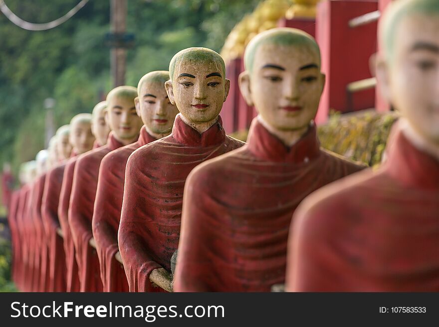 Buddhist monks stone statues row at Kaw Ka Thaung cave