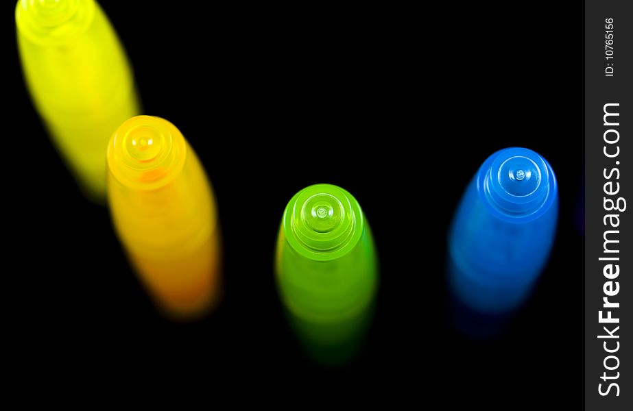 Colorful highlighters isolated on black background