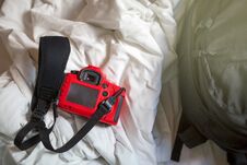 Camera And Bag On A Bed In The Morning. Stock Image