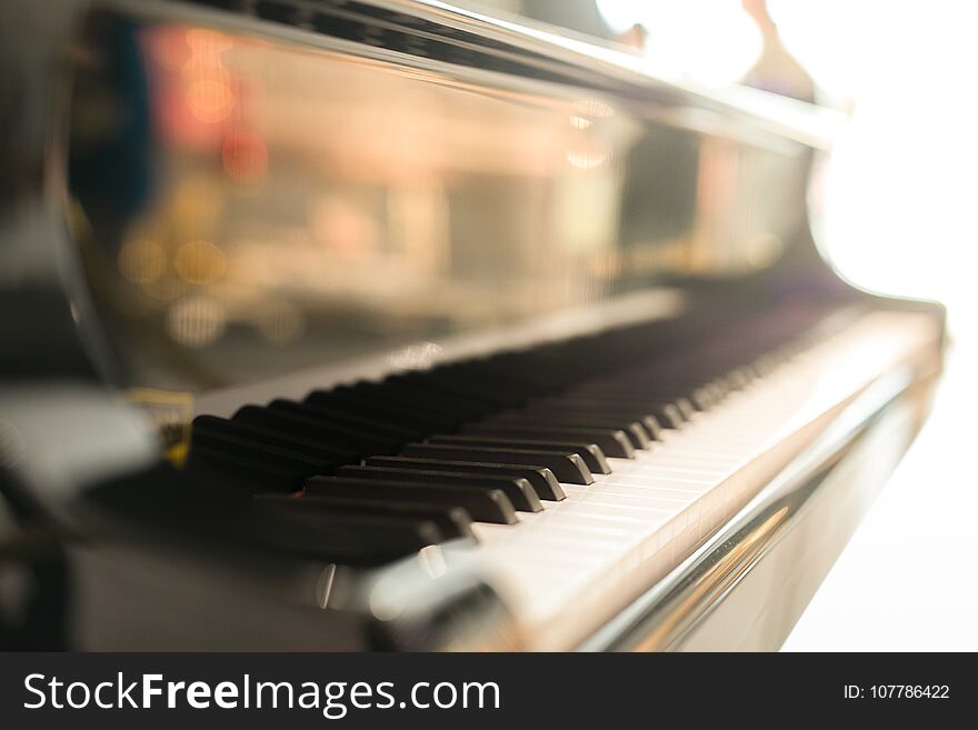 Black grand piano has piano key placed in hallroom. this image for music artist art instrument entertainment concept.