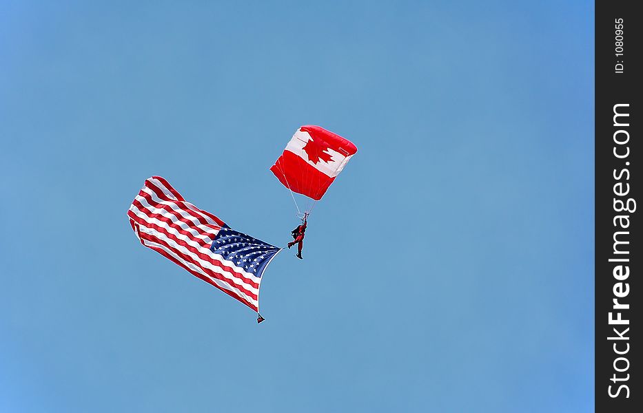 Canadian parachutist carrying US flag