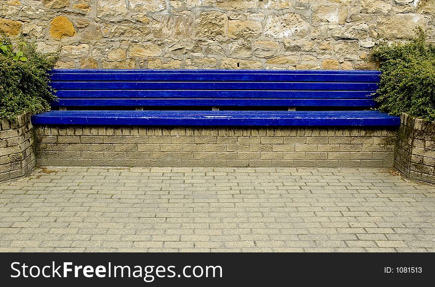 Blue city bench with block paving. Blue city bench with block paving