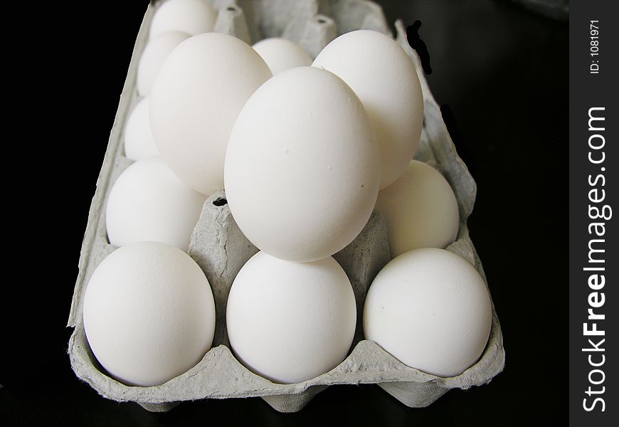 Extra large white egges piled in a carton. Extra large white egges piled in a carton