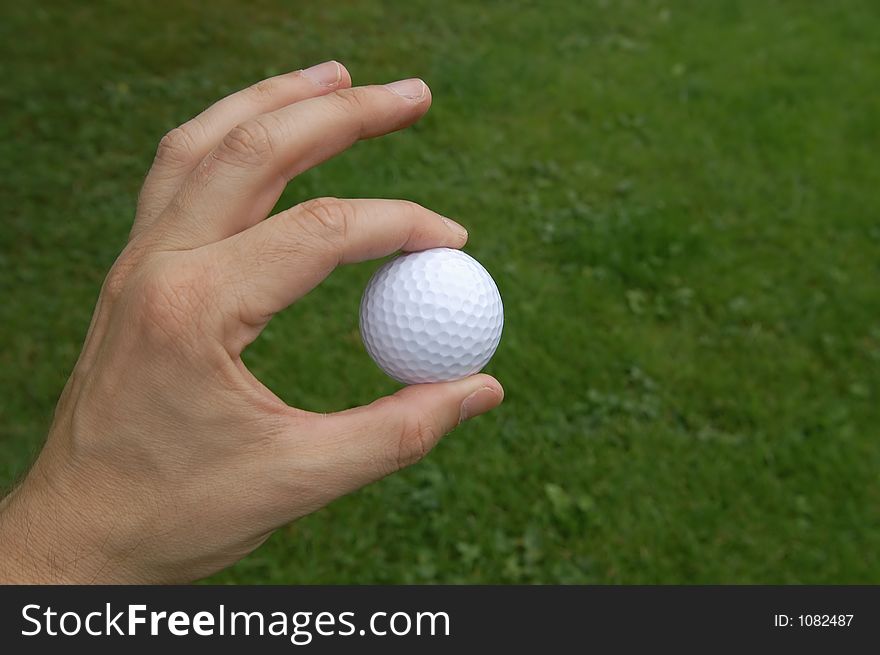 Hand handing a golf ball