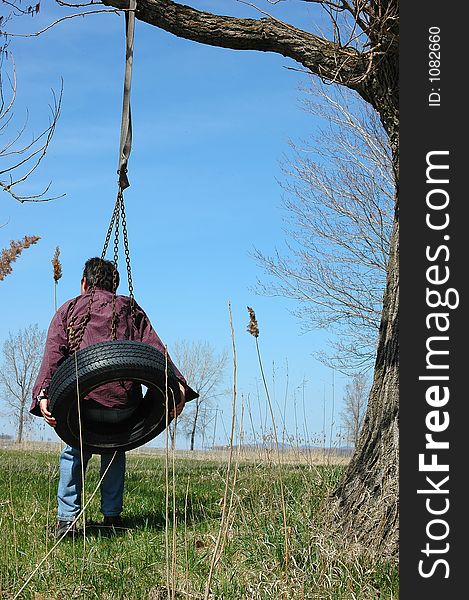 Active man on swing tire. Active man on swing tire