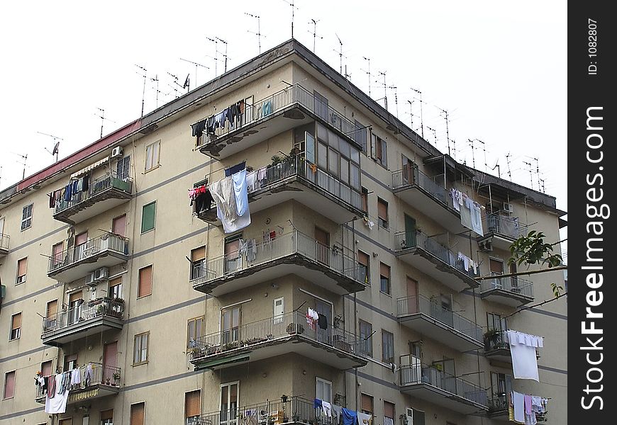 Typical  Europeans streetscapes in the Mediterranean coast with apartments houses, antennas on the roofs  and clotheslines on the balconies, Herculaneum City,  Italy. Typical  Europeans streetscapes in the Mediterranean coast with apartments houses, antennas on the roofs  and clotheslines on the balconies, Herculaneum City,  Italy