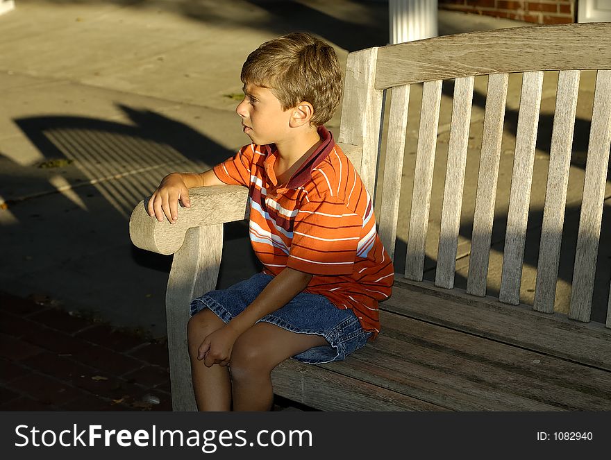 Young Boy SItting on a Bench. Young Boy SItting on a Bench