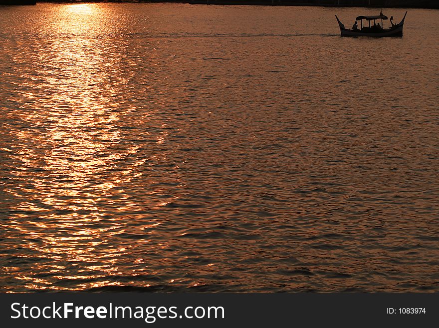 Couples enjoying gondola ride in sunset. Couples enjoying gondola ride in sunset