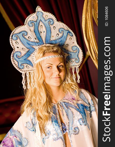 A dancer portrait in the theme of traditional Russian clothing. Artistic interpretation in dramatic lighting setup. A dancer portrait in the theme of traditional Russian clothing. Artistic interpretation in dramatic lighting setup.