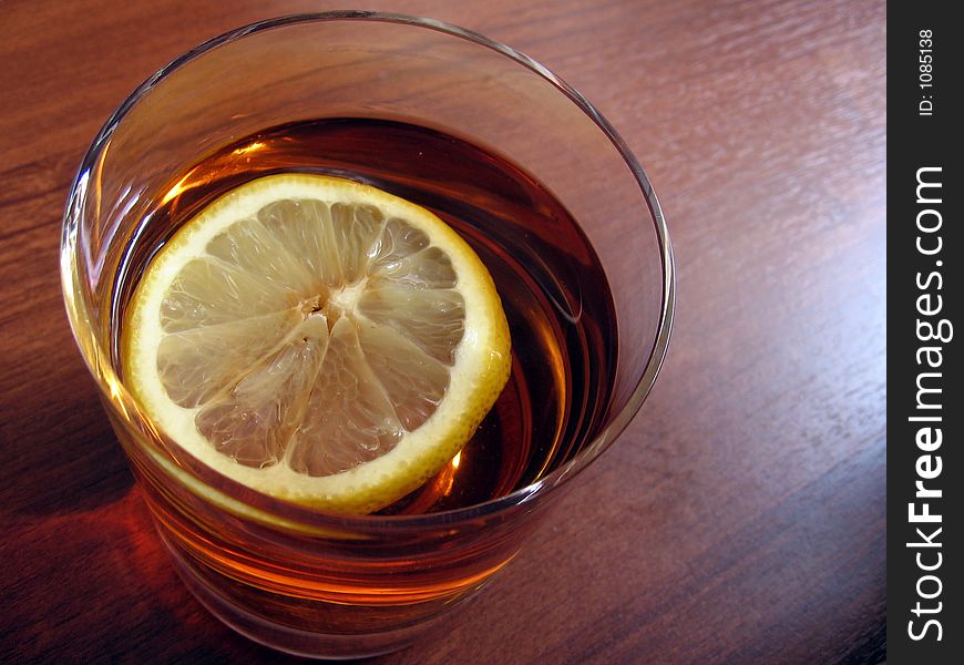 Black tea with lemon in the glass. Black tea with lemon in the glass