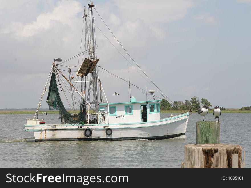 Fishing boat in the water off the pier