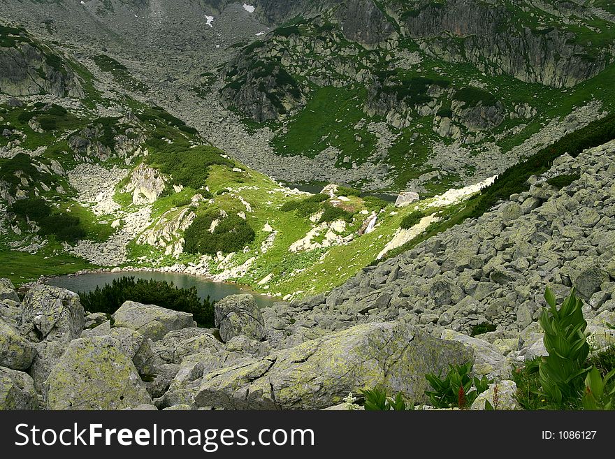 Lost glacial lakes with small water fall in Retezat Mountains - Romania. Lost glacial lakes with small water fall in Retezat Mountains - Romania