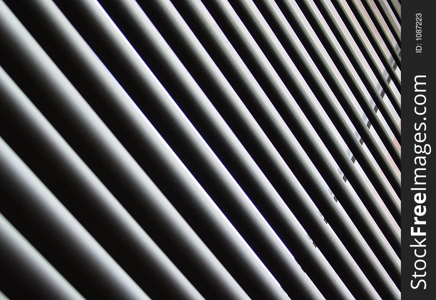 Abstract of blinds taken on a diagonal angle with shadows. Black and white. Abstract of blinds taken on a diagonal angle with shadows. Black and white.