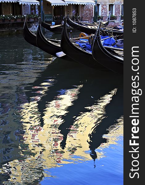 Gondolas in a Venetian canal. Gondolas in a Venetian canal