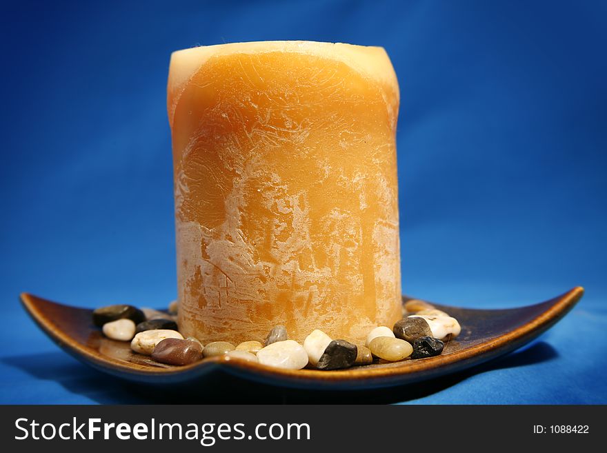 Decorative candle in a dish with tiny rocks