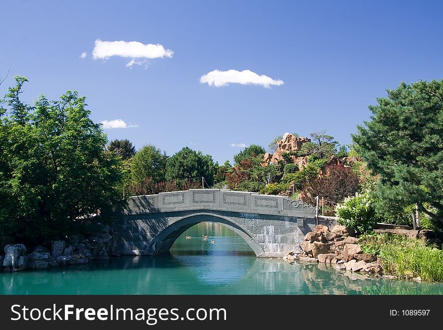 A gorgeous stone bridge crosses the pond of the Chinese garden at the Montreal Botanical Gardens.