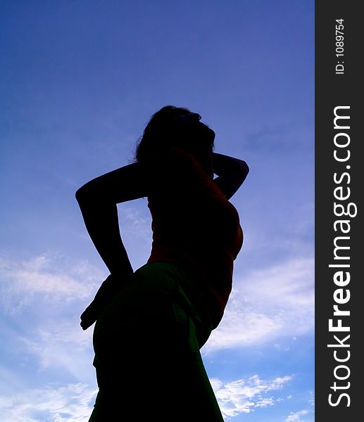 Feminine silhouette on background sky