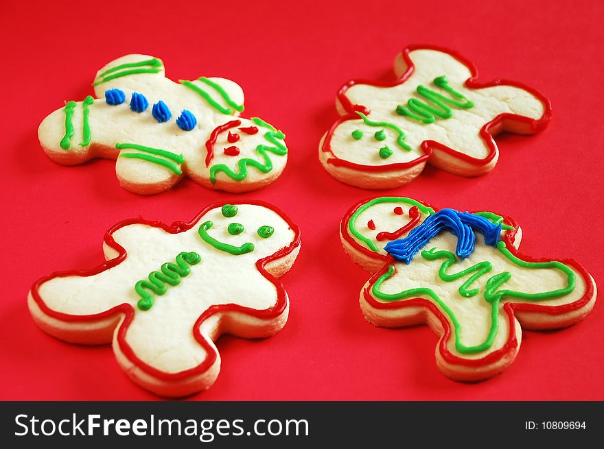 Gingerbread men cookies on red background. Gingerbread men cookies on red background