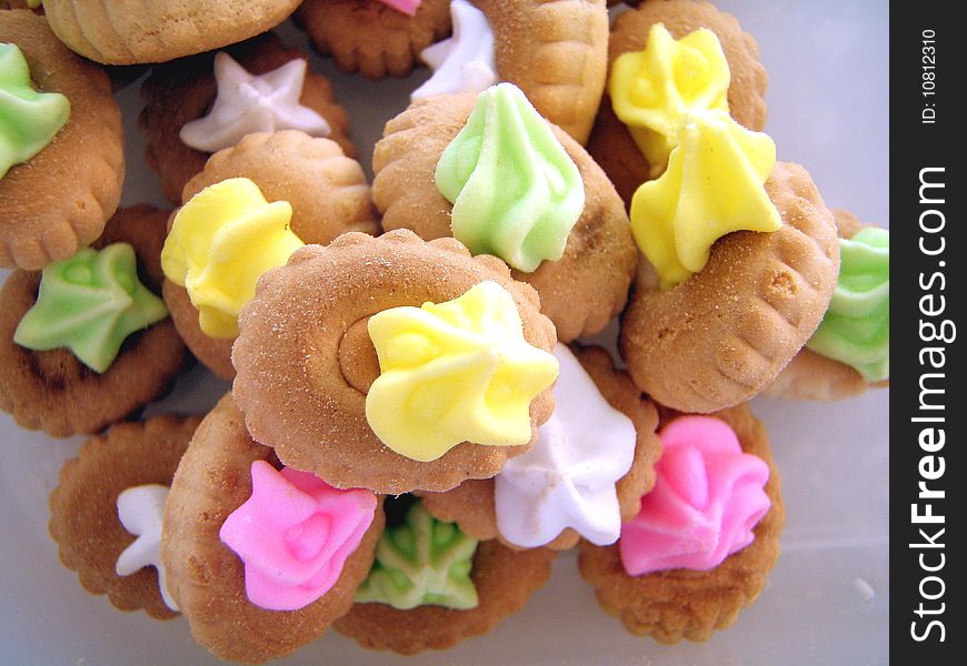 Cookies With Colorful Cream On Top.