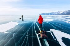 Woman With A Sledge Walk Is On The Ice Of Lake Baikal Royalty Free Stock Photos