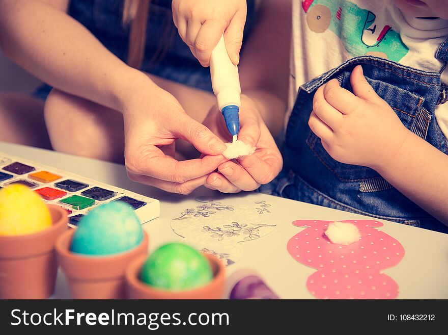 mother with kid making paper bunny hands close up