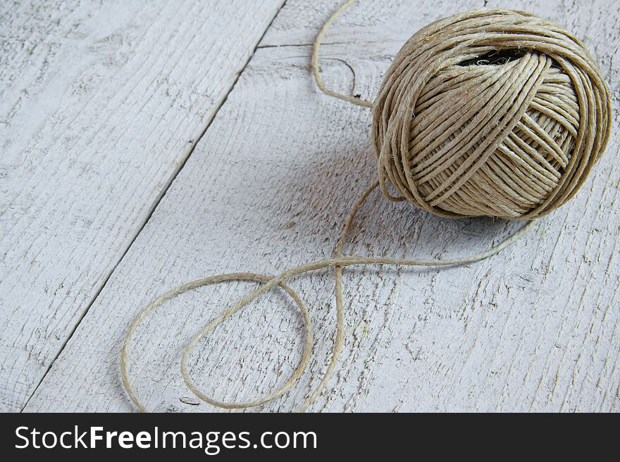 Ball Of Hemp Twine On White Wooden Background With Space For Text