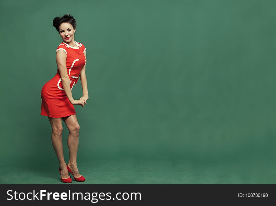 In red dress on green background girl in vintage style