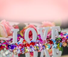 White Love Letter Inside Colorful Diamonds. Royalty Free Stock Photo