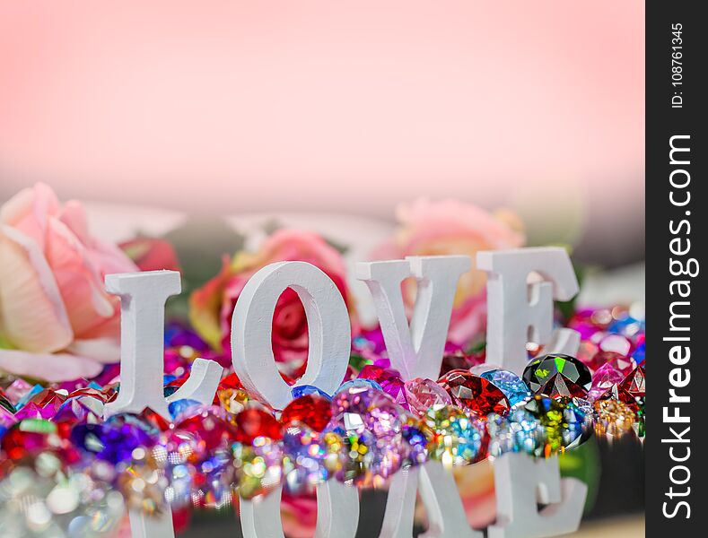 The word love is located on the area of colorful diamonds and roses, the word love is love for Valentine`s Day. The word love is located on the area of colorful diamonds and roses, the word love is love for Valentine`s Day.