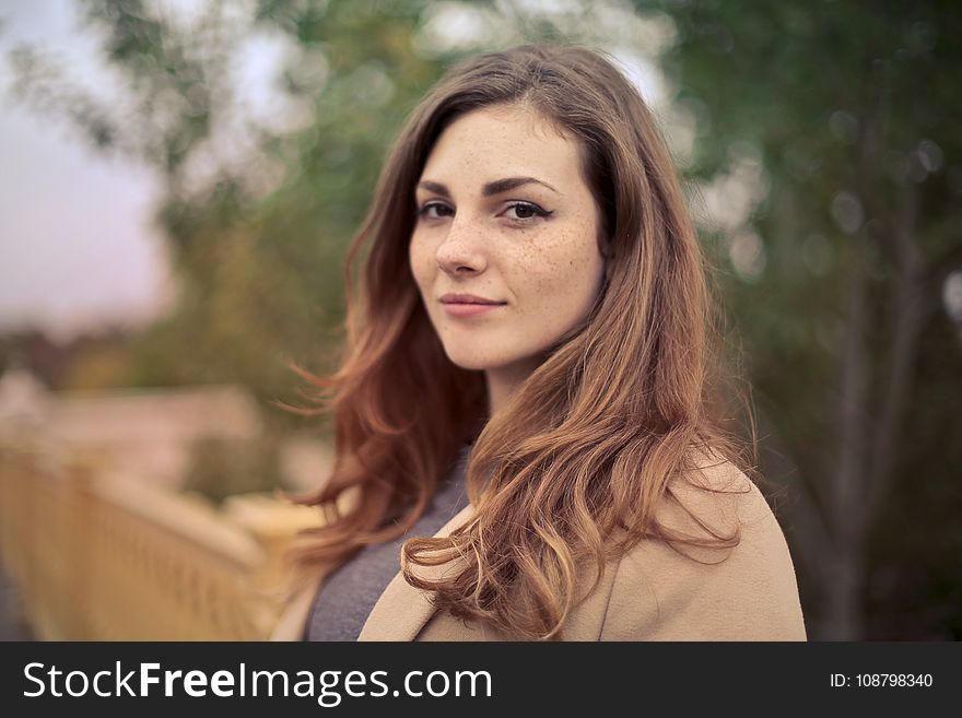 Closeup Photo Of Woman With Brown Coat And Gray Top