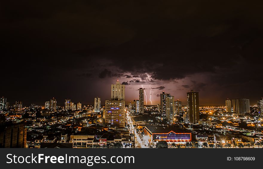 Thunderstorms Above City during Night Time