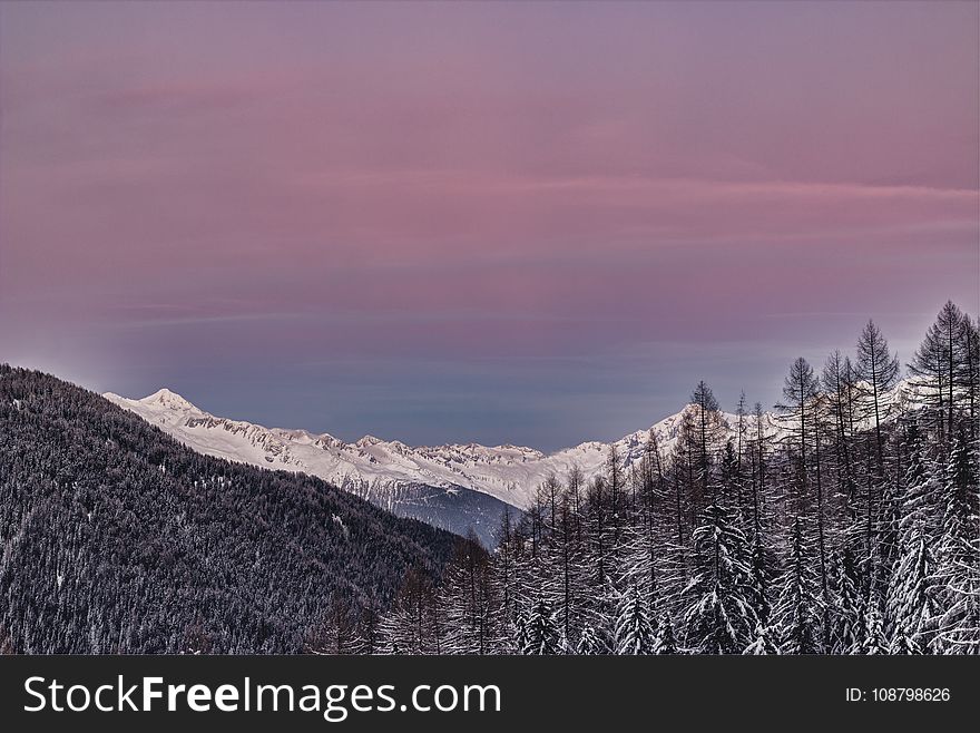 Photo Of Mountains Covered With Snow And Surrounded With Trees