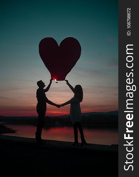 Silhouette Photo Of Man And Woman Holding Heart Lantern