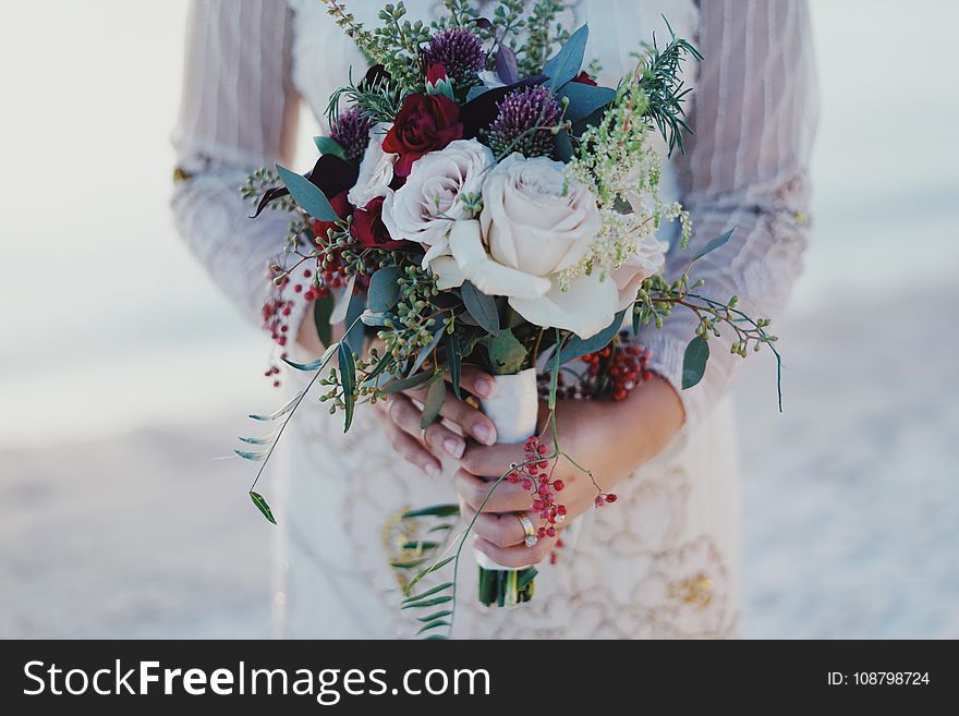 Woman Holding Red and White Rose Bouquet