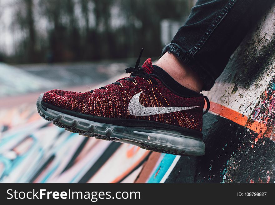 Close-Up Photography of Red and Black Nike Running Shoe