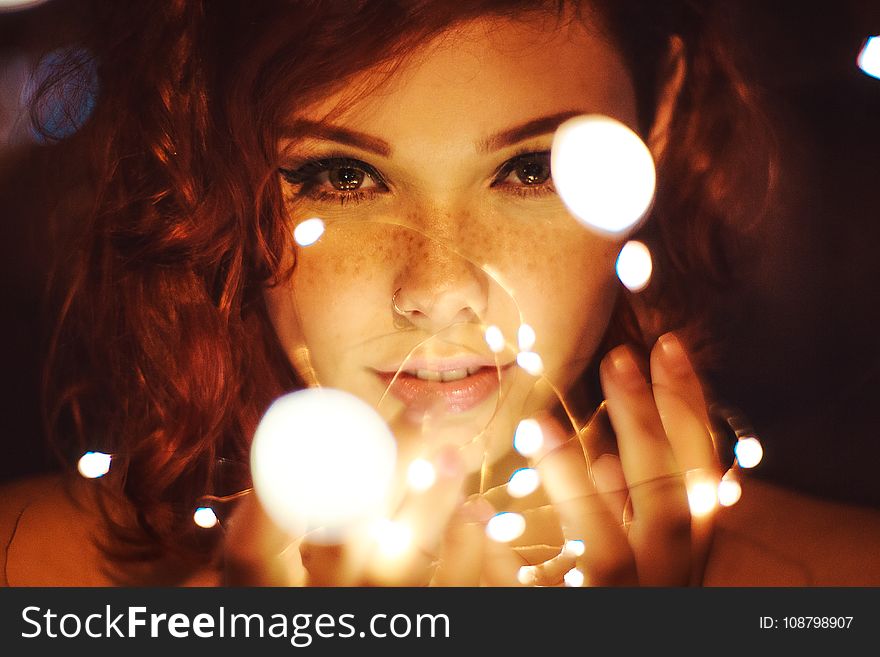 Photography of a Woman Holding Lights