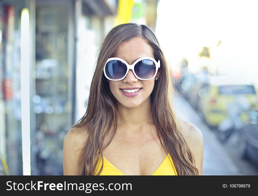 Woman Wearing Yellow Spaghetti Strap Top and Round Sunglasses