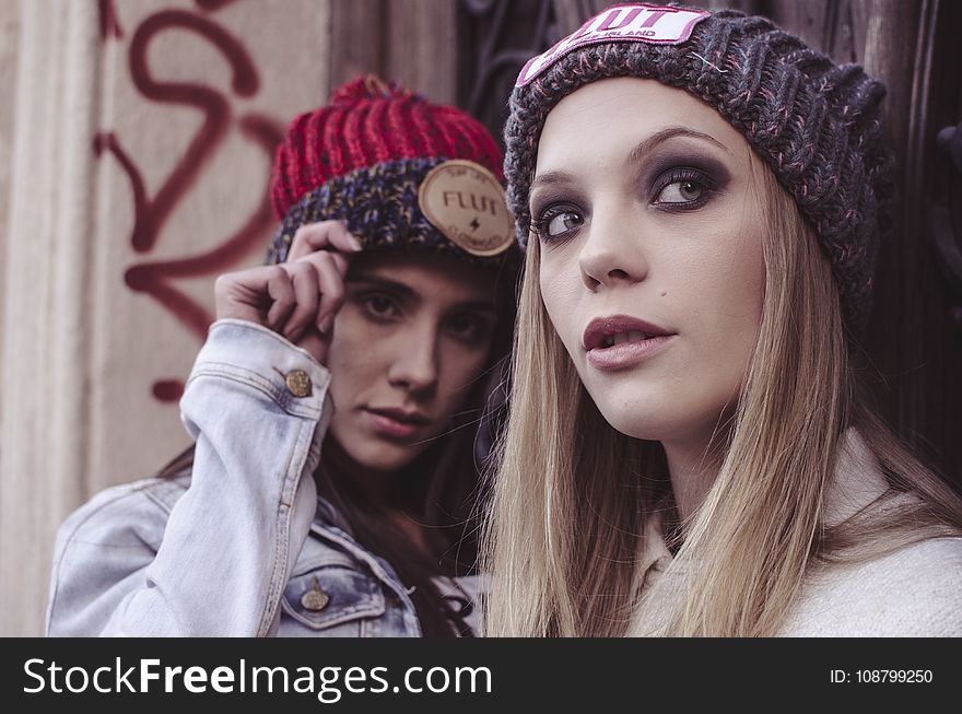 Two Women In Beanie Caps Taking Selfie