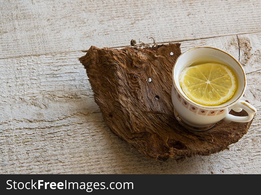 Cup of tea on wooden table with space fot text