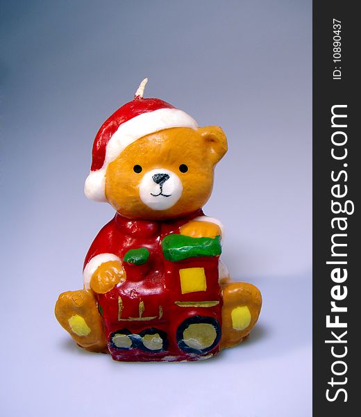 Candle of a cute teddy bear waiting christmas time. Candle of a cute teddy bear waiting christmas time