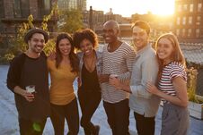 Friends At A Rooftop Party In Brooklyn Smiling To Camera Royalty Free Stock Photography