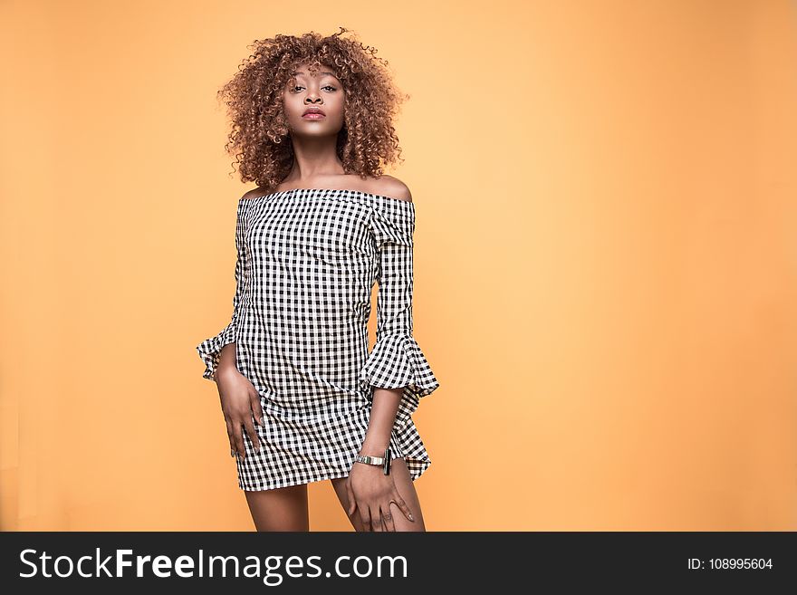 Woman Wearing Checked Bell-sleeved Dress With Orange Background