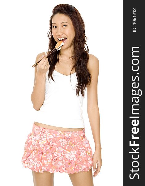 A pretty young asian woman eating salmon sushi with chopsticks