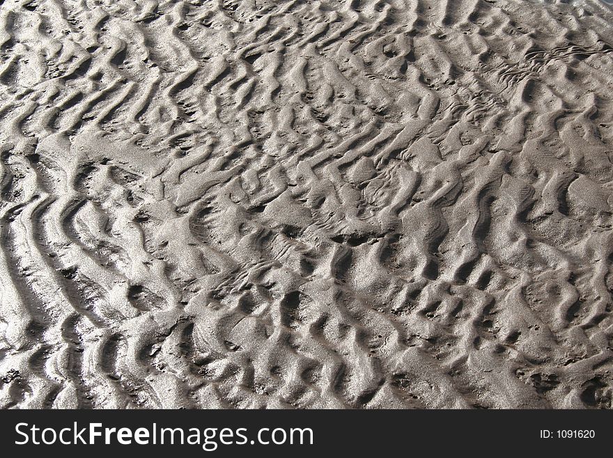 Wet sand on a beach. Wet sand on a beach