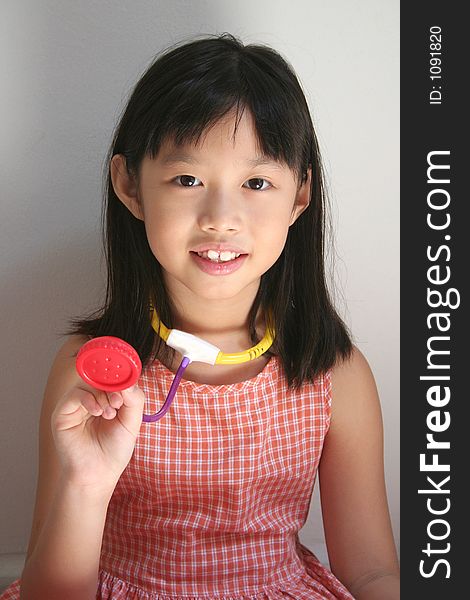 Girl holding stethoscope